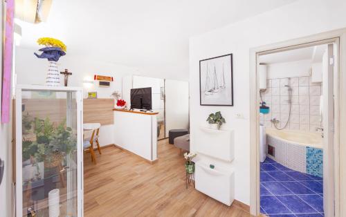 a room with a bathroom with a sink and a tub at Apartments Joy in Cavtat
