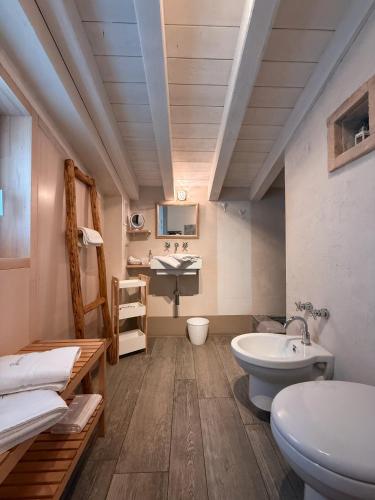a bathroom with a sink and a toilet at Biancaleo Homes in Affi