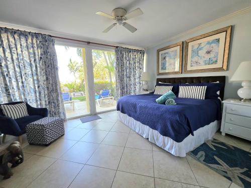 a bedroom with a bed and a sliding glass door at 117 Sapphire Beach Condo in Christ Church