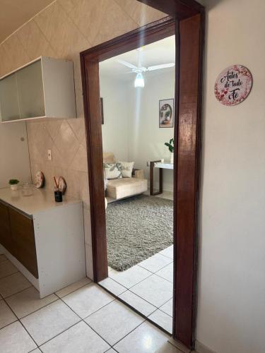 a kitchen with a door open to a living room at Casa do Bosque in Sao Jose do Rio Preto