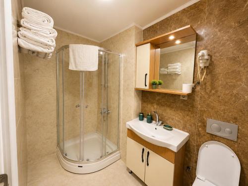 a bathroom with a shower and a toilet and a sink at Stay Istanbul Hotel in Istanbul