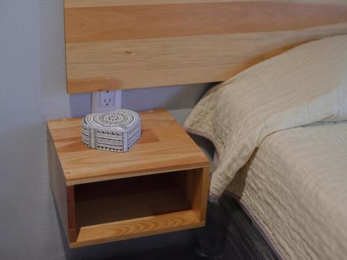a wooden bedside table with a box on it at Margarita in Oaxaca City