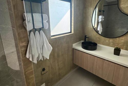 a bathroom with a sink and a mirror at TokioLiving in Armenia