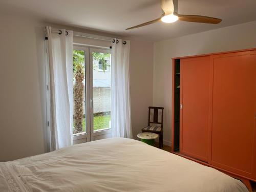 a bedroom with a bed and a large window at Villa de charme jardin vue sur montagnes rénovation 2026 in Argelès-Gazost