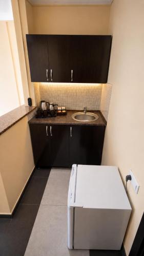 a small bathroom with a sink and a counter at Sunny Beach Hotel in Kobuleti