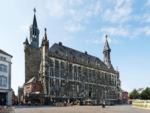 a large building with two towers on top of it at ibis budget Aachen City in Aachen