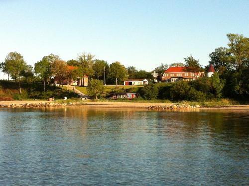 a large body of water with houses in the background at Loff Holiday Houses in Aabenraa