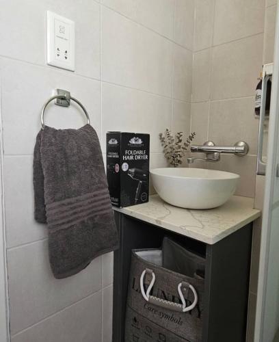 a bathroom with a sink and a bowl on a counter at Montgomery Highlands Estate in Harare