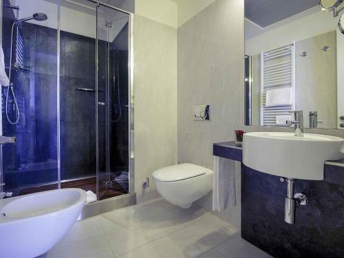 a bathroom with a sink and a toilet and a shower at Hotel Mercure Milano Solari in Milan