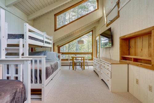 a bedroom with bunk beds and a dining room with a table at Resort-Style Community! Quechee Chalet w/ Deck in Quechee