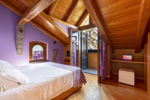 a bedroom with a large bed and wooden ceilings at Villa Di Natale in Pagani