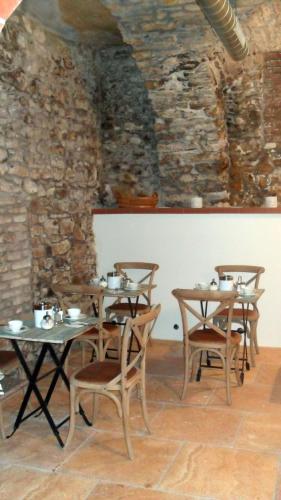 a room with tables and chairs and a stone wall at Jungmann Hotel in Prague