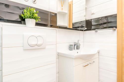 a bathroom with white cabinets and a sink at Apartments Adriatic Relax, heated pool, parking place in Duće