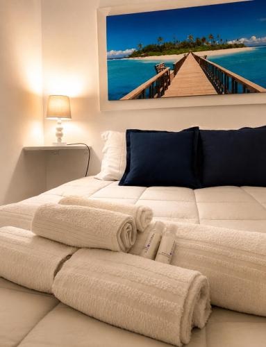 a bedroom with two beds with towels on it at Carbonari Holiday House in Cefalù