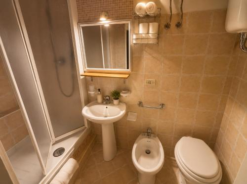 a bathroom with a toilet and a sink and a shower at Carbonari Holiday House in Cefalù