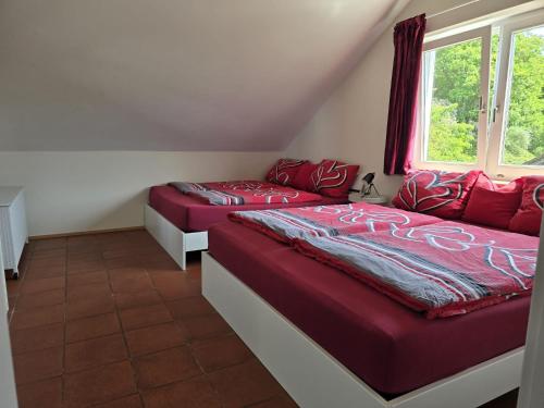a bedroom with two beds and a window at 'Tor zum Schwarzwald' Ferienwohnungen mit Sauna in Wildberg