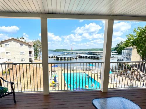 a balcony with a view of a swimming pool at Lake of the Ozarks Waterfront Kapilana Resort Condos - Pool, Dock, Grill, Boat Rentals Fishing & Lake Views in Osage Beach