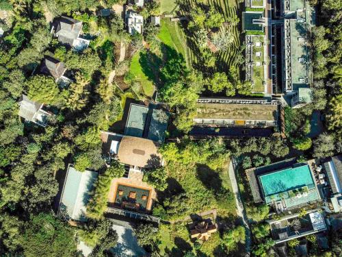 an overhead view of a yard with a house and a pool at Veranda High Resort Chiang Mai - MGallery Collection, Accor Hotel in Hang Dong