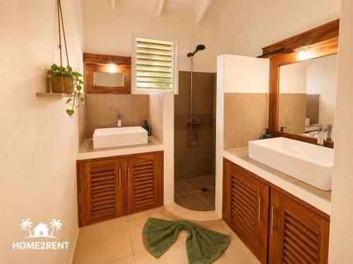 a bathroom with a sink and a mirror at Villa 300m from beach with shared swimming pool in Las Terrenas