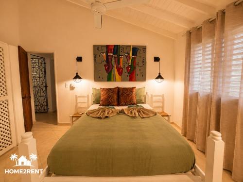 a bedroom with a large bed in a room at Villa 300m from beach with shared swimming pool in Las Terrenas