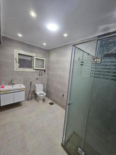 a bathroom with a shower and a toilet and a sink at فيلا في كينج مريوط in Alexandria