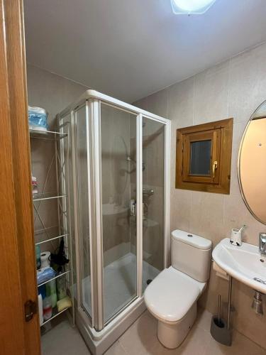 a bathroom with a shower and a toilet and a sink at Casa Isabel, wifi y relax - Arafita Apartamentos in Sallent de Gállego