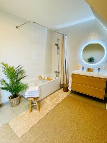 a bathroom with a tub and a toilet and a sink at Villa Everbeur te Averbode in Scherpenheuvel-Zichem