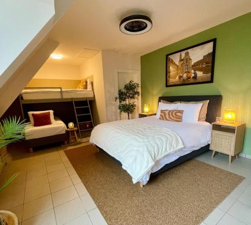 a bedroom with a large bed with a green wall at Villa Everbeur te Averbode in Scherpenheuvel-Zichem
