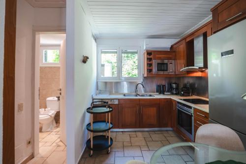 a kitchen with a sink and a stove top oven at Corfu Glyfada Beach Apartment 13 in Glyfada