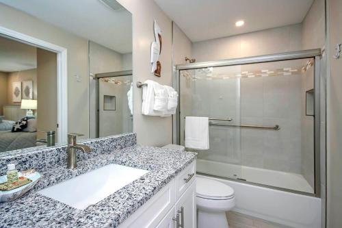 a bathroom with a shower and a sink and a toilet at Sanibel Arms West Unit A1 in Sanibel