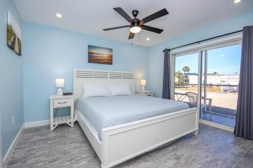 a bedroom with a bed and a ceiling fan at Unit D2 in Sanibel