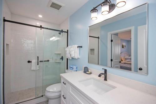 a bathroom with a sink and a glass shower at Unit D2 in Sanibel