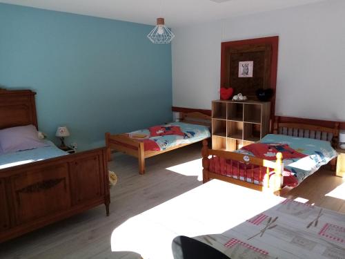 a room with three beds in a room at Le Flocon in Prémanon