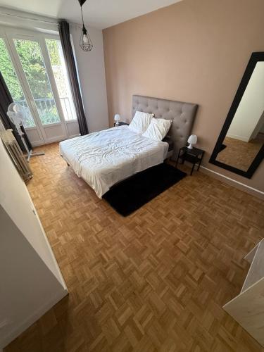 a bedroom with a bed and a large window at LebonCosy in Limoges