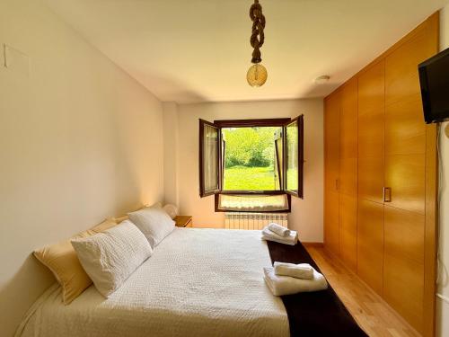 a small bedroom with a bed and a window at Cozy apartment with mountain views in Panticosa