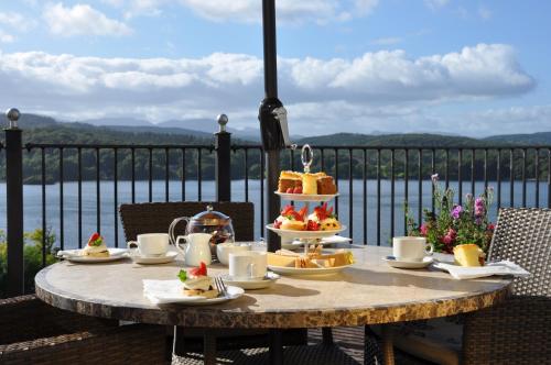 a table with a cake on top of a balcony at Beech Hill Hotel & Spa in Windermere