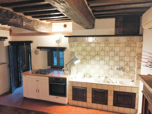 a kitchen with two sinks and a stove at Tudesia Charming house in Todi