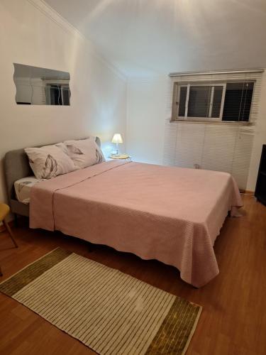 a bedroom with a large bed and two windows at House Heart in Amora