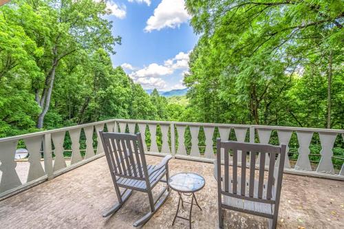 two chairs and a table on a balcony with trees at Grin and Bear It in Whittier