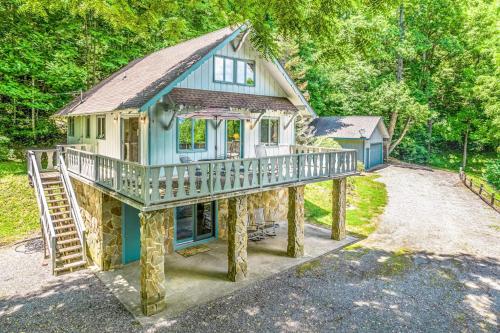 a blue house with a porch and a staircase at Grin and Bear It in Whittier