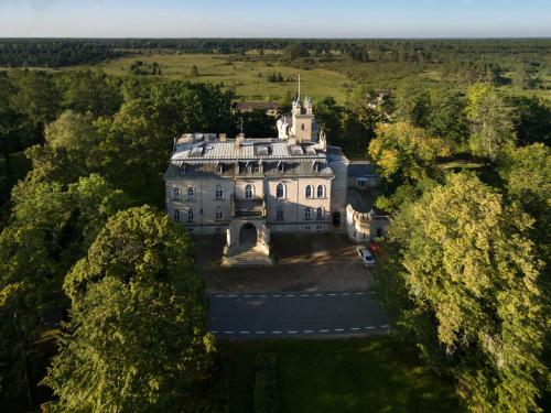 an aerial view of a large house with trees at Laitse Castle B&B in Laitse