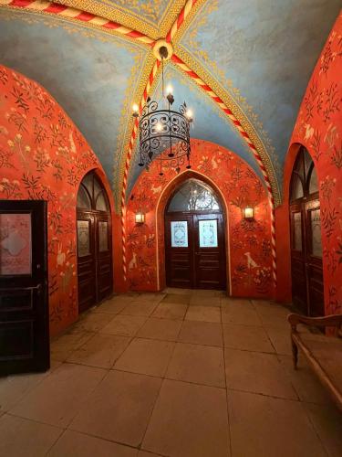 a room with red walls and a ceiling with doors at Laitse Castle B&B in Laitse