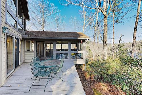 a porch of a house with a table and chairs at Narnia on Earth in Lake Lure