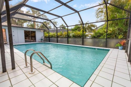 an indoor swimming pool with a glass roof and a swimming poolvisor at Naples Luxury 5BDRM HomeHtd PoolSuperCleanPets in Naples