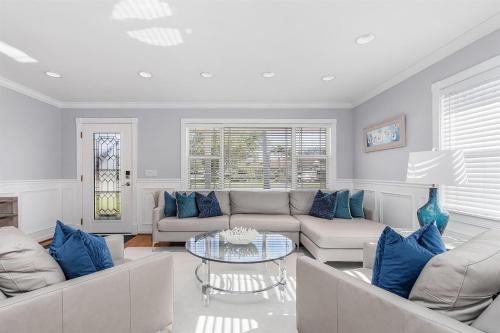 a living room with couches and a table at Naples Luxury 5BDRM HomeHtd PoolSuperCleanPets in Naples