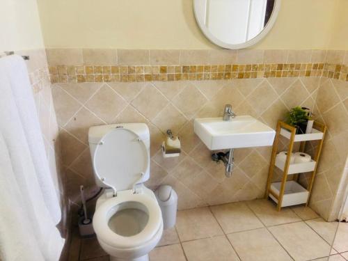a bathroom with a toilet and a sink at Ocean View Villas F05 in Port Edward
