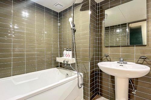 a bathroom with a sink and a bath tub and a sink at Ramon Hotel in Seoul