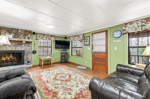 a living room with a couch and a fireplace at Hidden Creek Cabin in Franklin