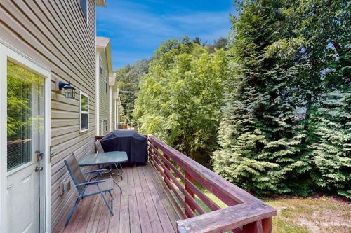 a wooden deck with a table and a bench on a house at Cool Springs Manor in Asheville