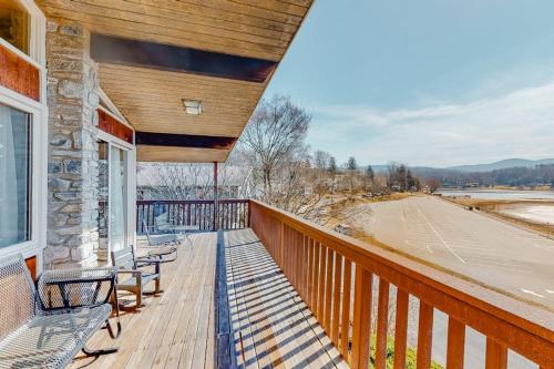 a porch with benches on a building with a view at Morris Villa Upper in Lake Junaluska